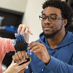 Student with robot hand