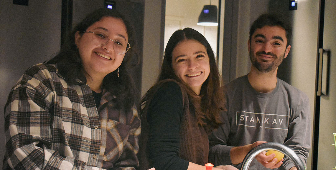 Group smiling students in a kitchen