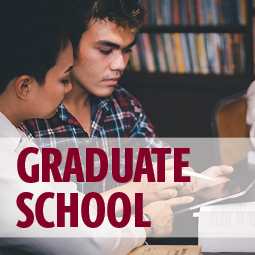 image of two graduate students studying in a library. text over image says "graduate school"