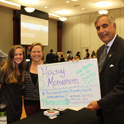 President Pastides posing with two students at the Sustaianbility Showcase