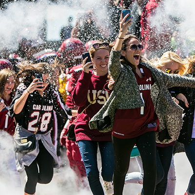 Students running and cheering