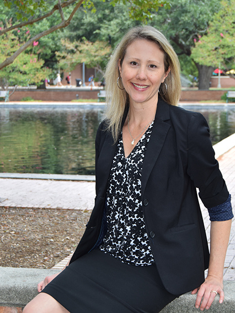 Digital Research Services librarian Stacy Winchester sitting outside Thomas Cooper Library by the fountain