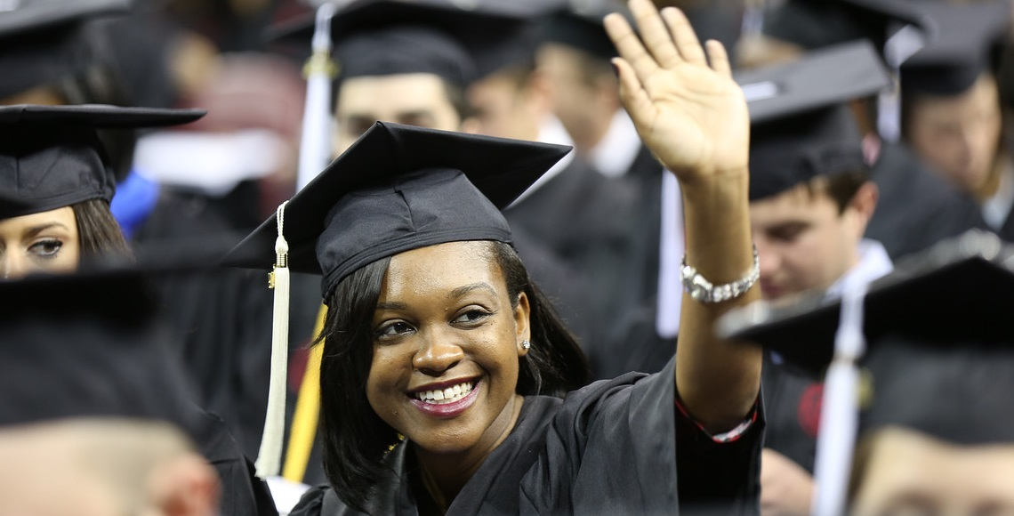 Palmetto College Graduate waves to friends