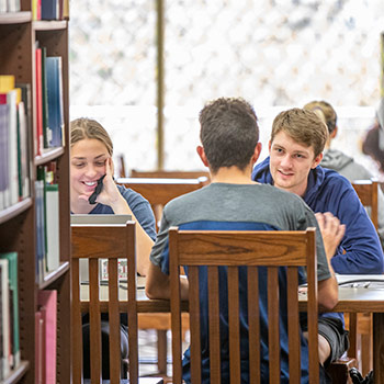 Table of students studying in the library.