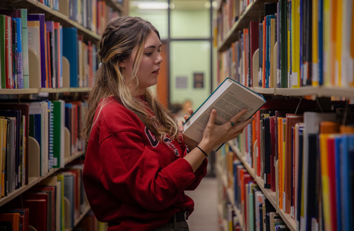 Student looking at a book.