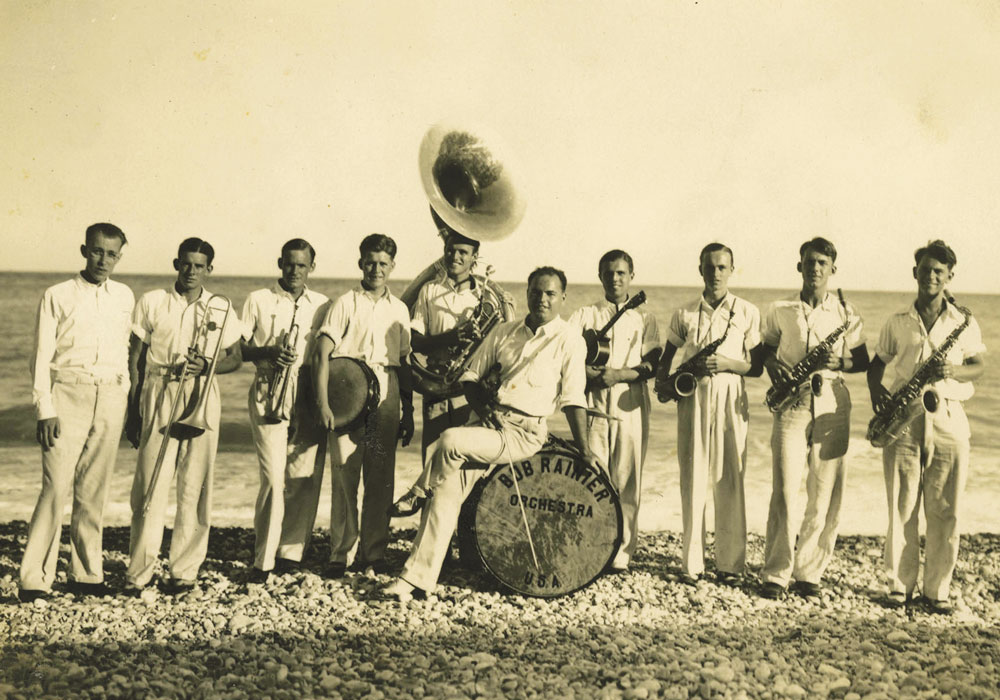 The Bob Ranier Orchestra poses with their instruments on the beach