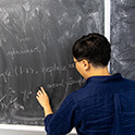 photo of professor writing on a black board