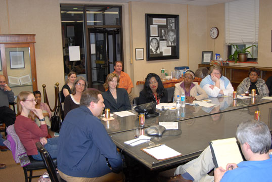 A group of people gathered in the Travelstead Room