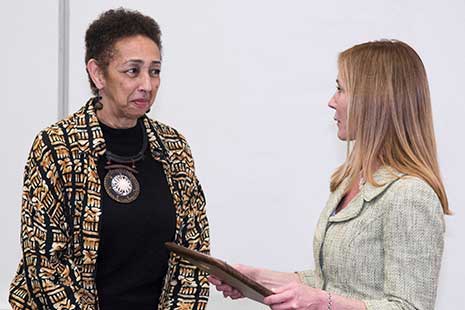 Ms. Monique Travelstead McNamara, granddaughter of Chester C. Travelstead, presents the Travelstead Award to Millicent E. Brown