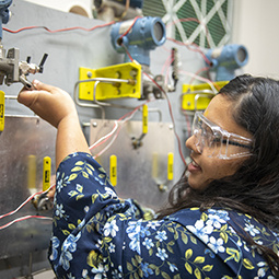 a professor helps a grad student in a lab