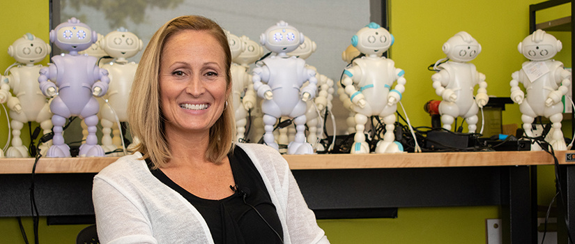 Laura Boccanfuso poses in front of her ABii robots