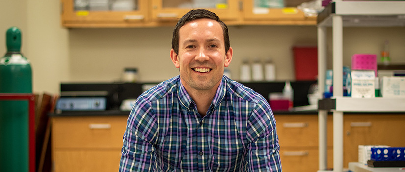 Gower sits in lab