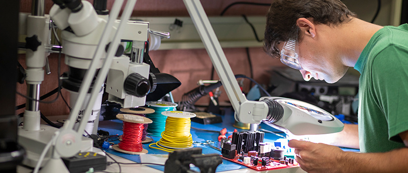 A student works on electrical equipment