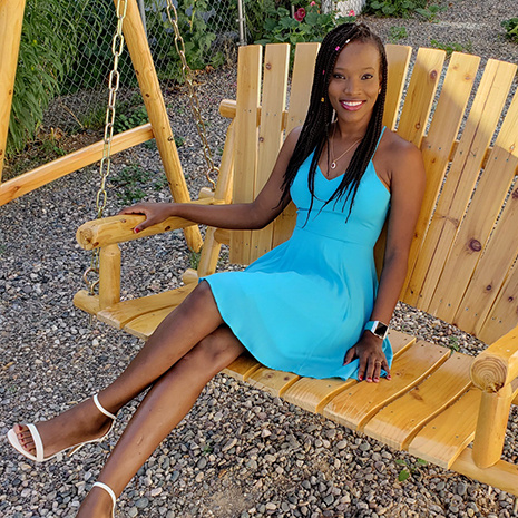 Tash Ulrisch sits on a wooden bench