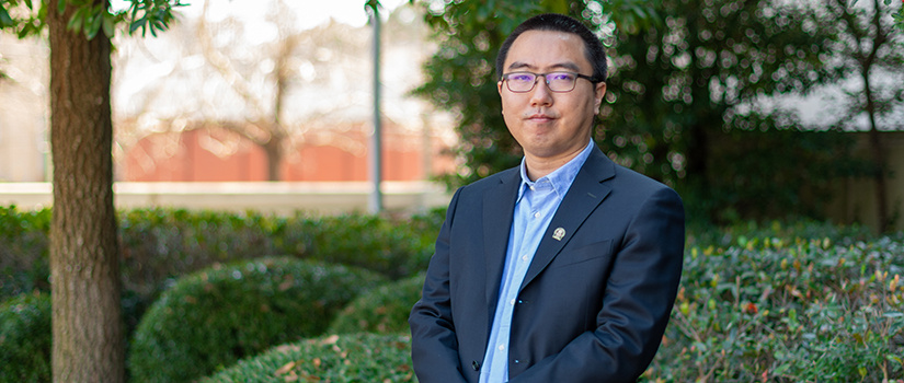 Chang Liu stands outside the Swearingen Building.