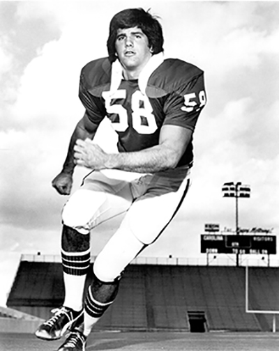 Mike McCabe in his football uniform, running on football field