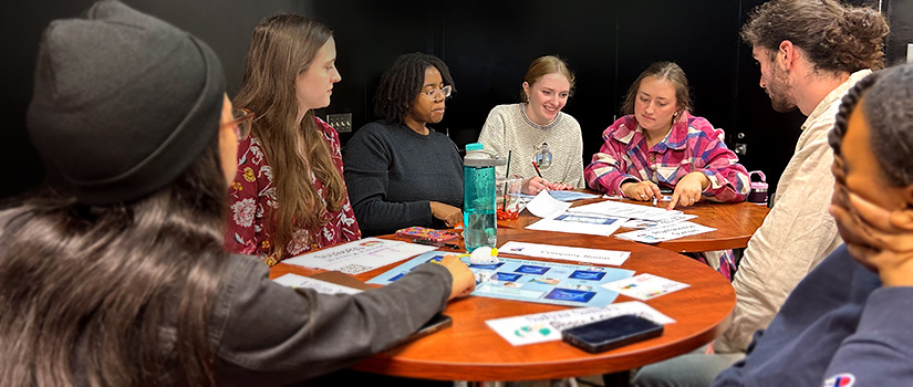 Students at a table playing a game