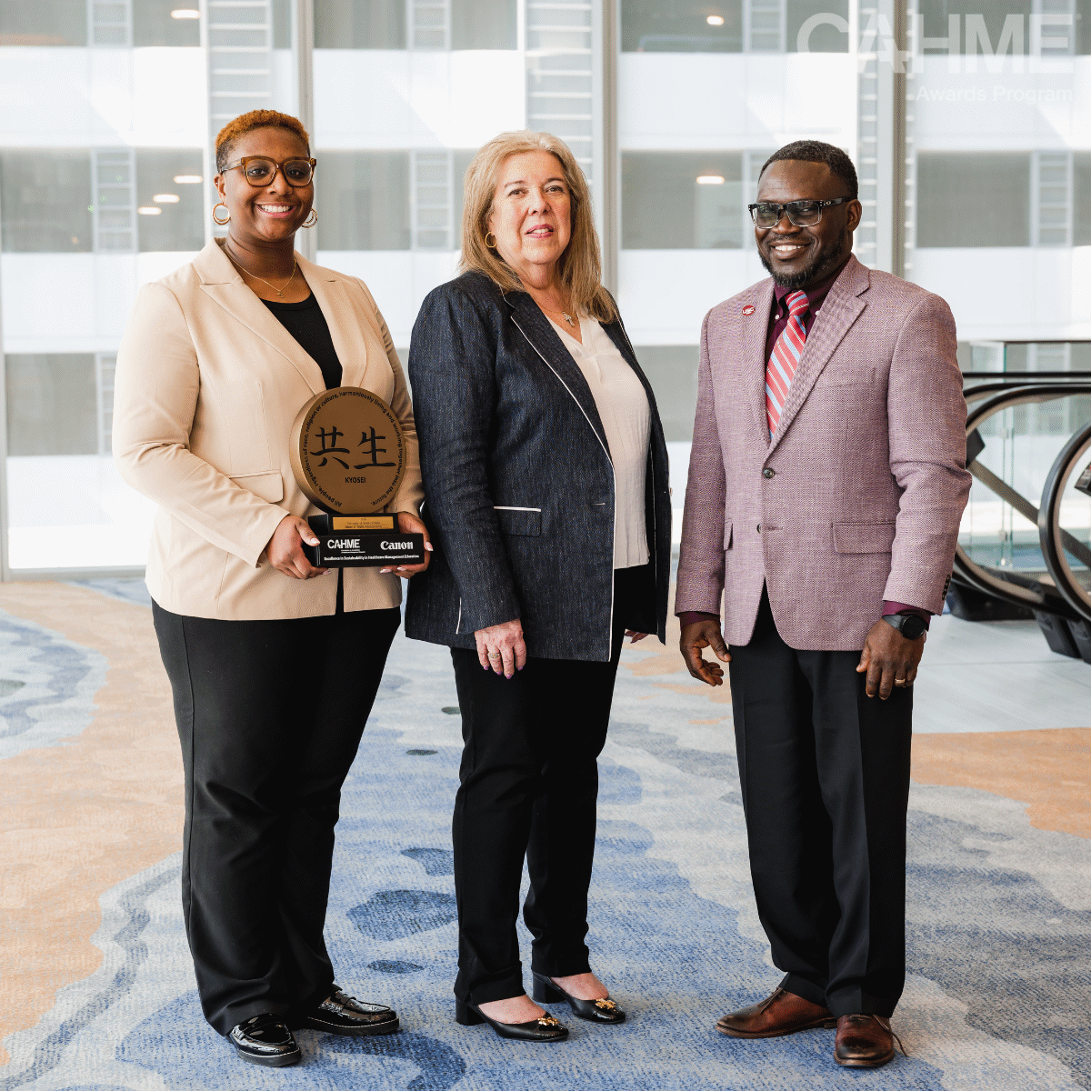 MHA Student Ciara Robinson, Canon Representative Debra Gillmeister, and HSPM faculty Bankole Olatosi
