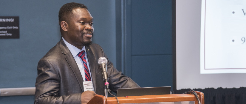 Faculty member Banky Olatosi speaking at a conference