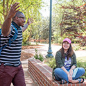 Students talking in front of the entrance to Hamilton College.