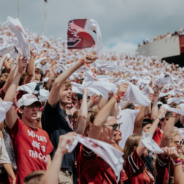 students at Williams-Brice waving white towels
