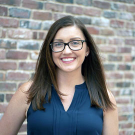 kassandra gove standing in front of a brick wall