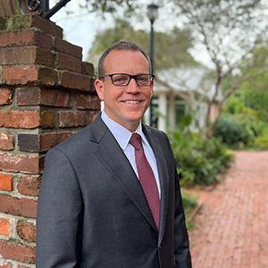 Thomas Hodges stands in front of the College of Education.