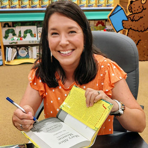 angela may signs a book in bookstore