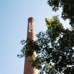 Photo of brick smokestack with USC in white letters